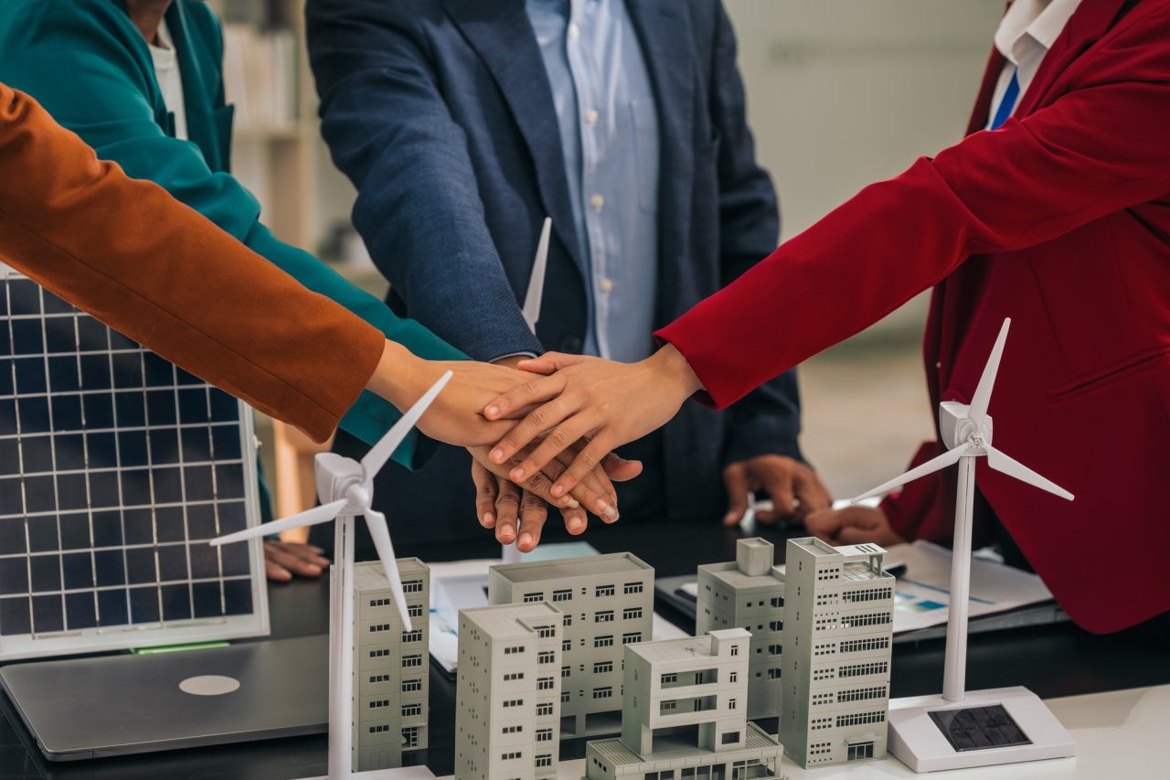 group asian business people meeting boardroom clean energy city solutions discussing solar panels